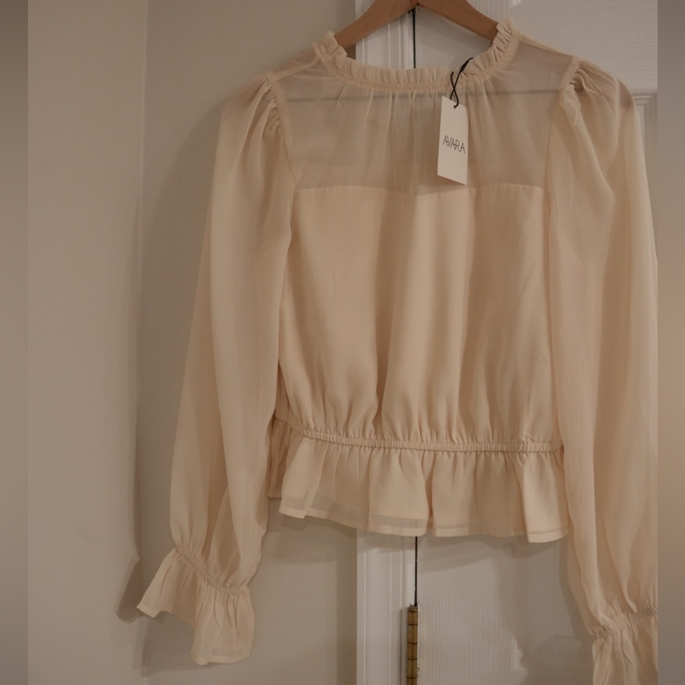 Avara’s Capri Ivory Peplum Top